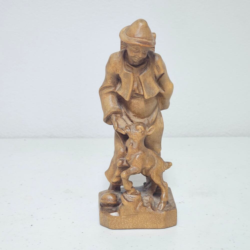 Handcarved Wooden statue boy with deer carrying a ladder and sleeping bag
